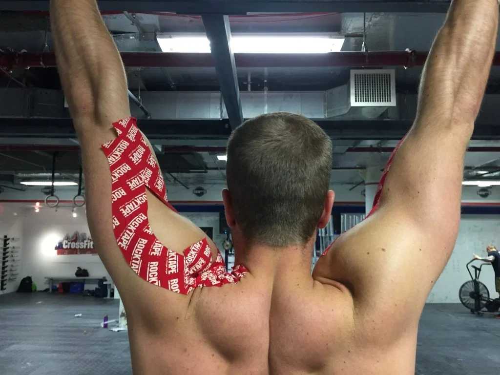a man doing a exercise with kinesio tape