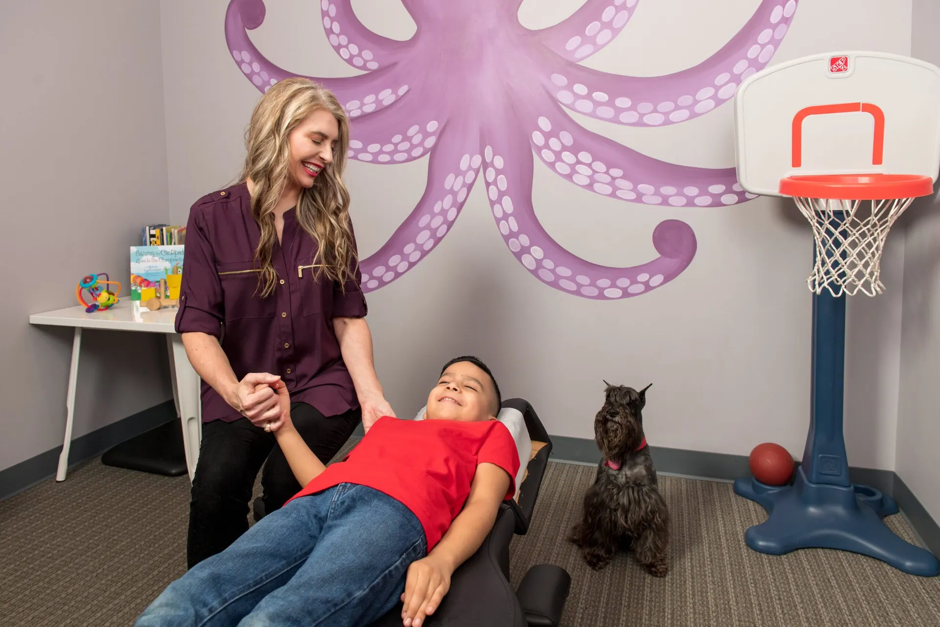 Dr Stacey Rodger giving a child a arm pain treatment