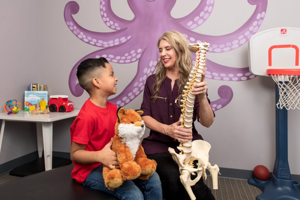 Dr Stacey Rodgers explaining the kid the spine