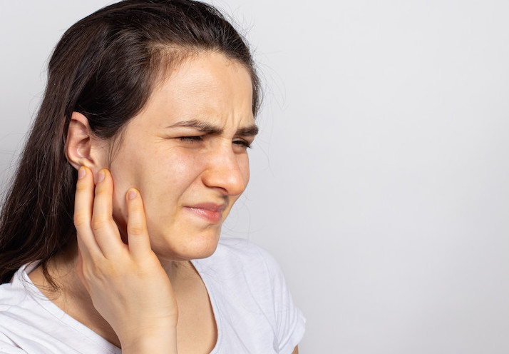 a woman suffering from tmd/tmj pain